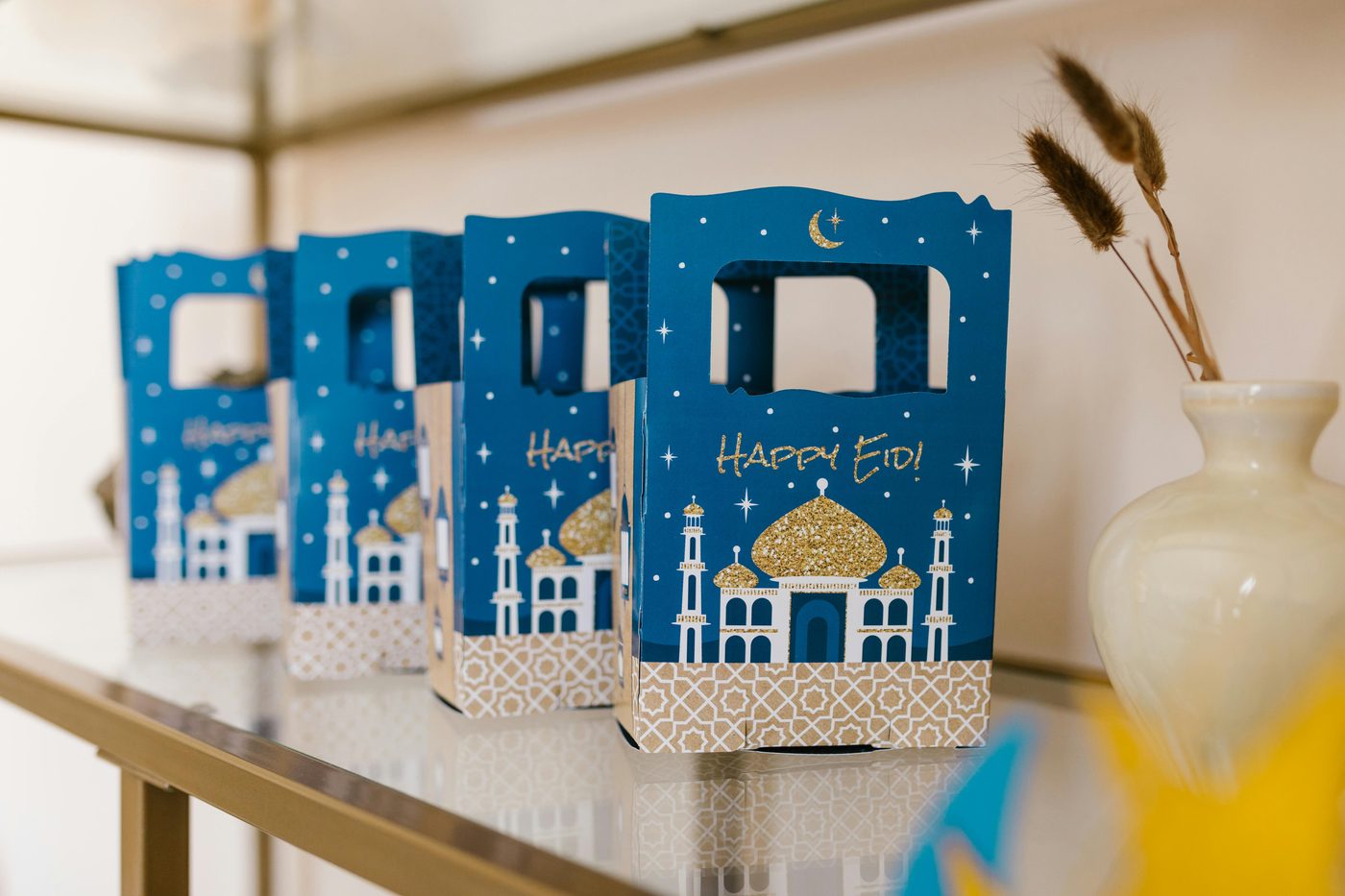 Happy Eid gift boxes decorated with blue and gold mosque designs — Eid ul Adha celebration gifts