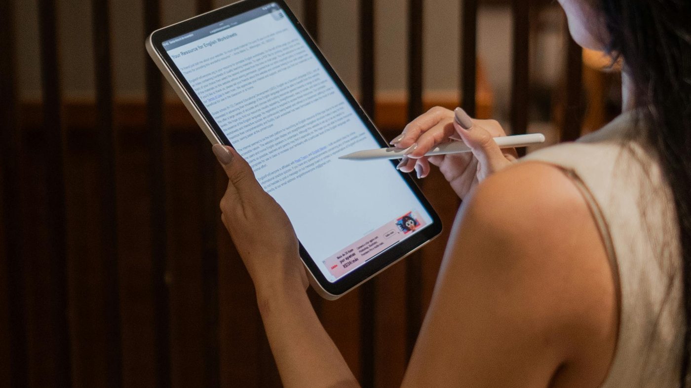 Professional reviewing and signing a document electronically on a digital tablet