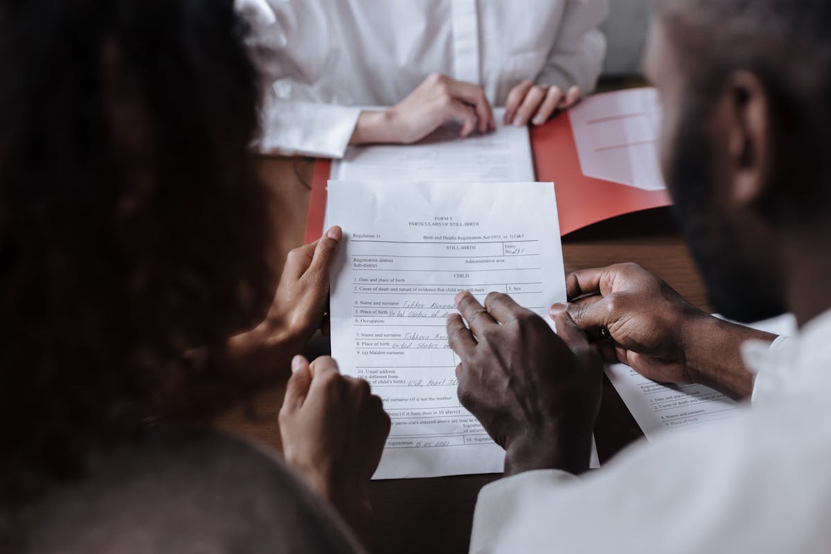 Two professionals reviewing and signing a legal agreement together