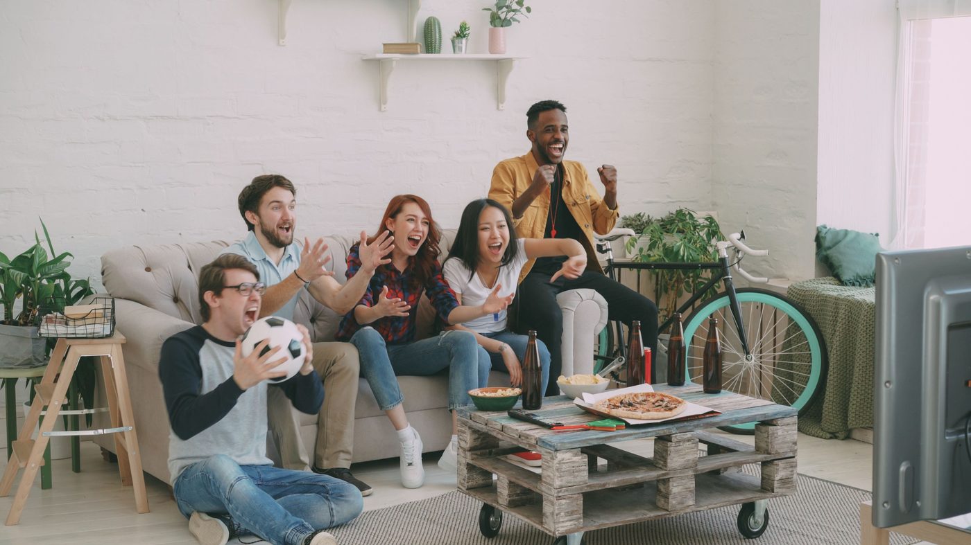 Group of friends cheering together at a FIFA World Cup 2026 watch party